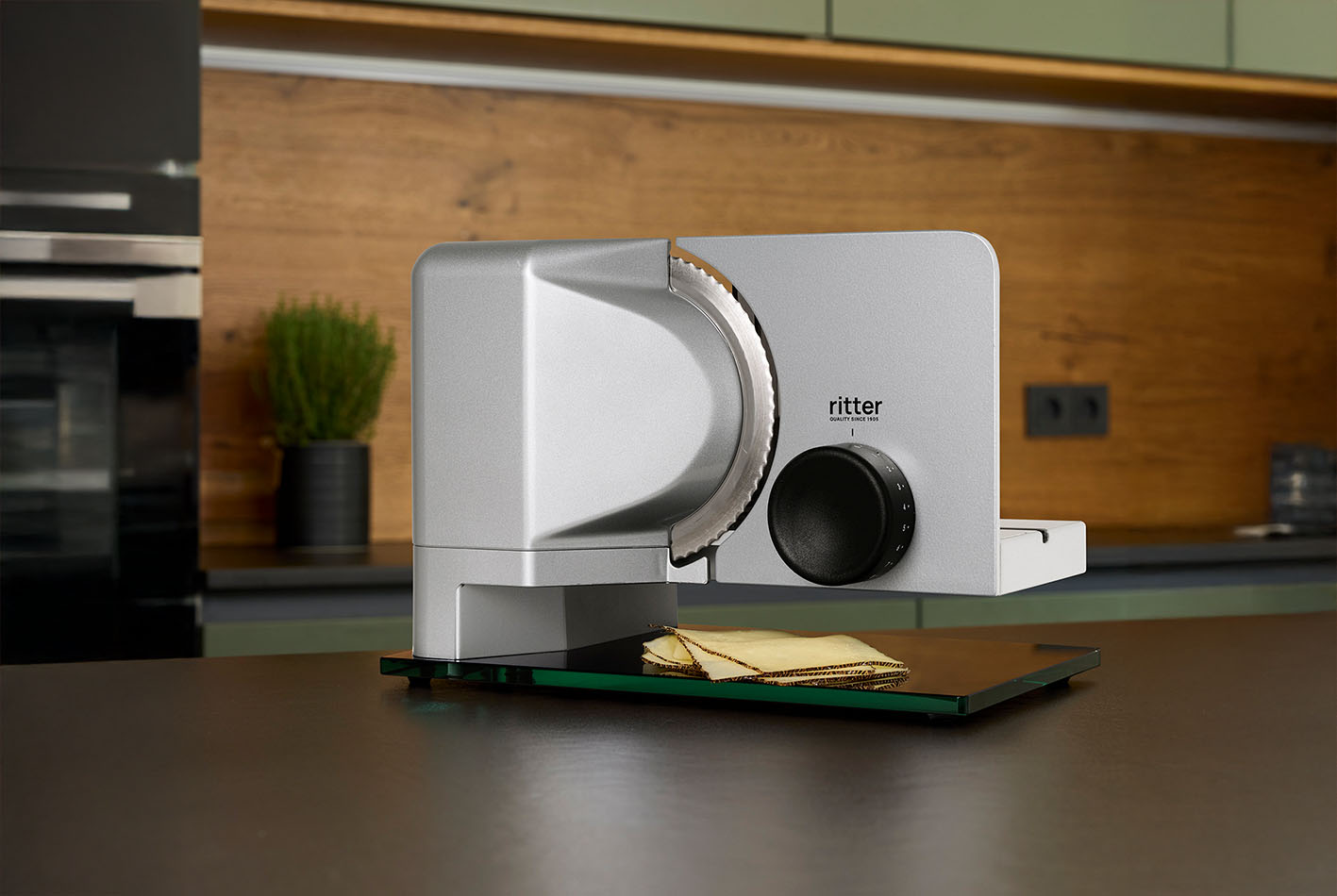 Electric food slicer with sliced cheese, in modern kitchen