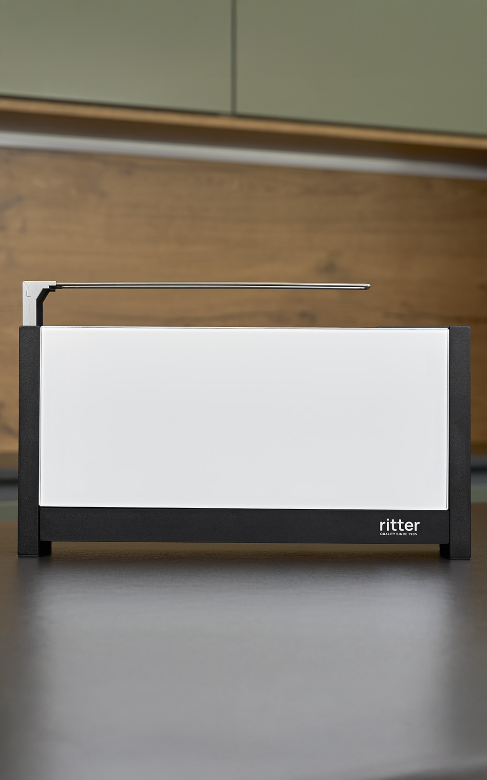 A picture of a white toaster standing on a kitchen platform. A picture of a white toaster standing on a kitchen platform.