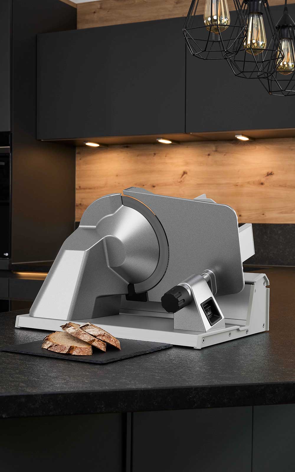 A picture of the deli slicer standing in a kitchen with slices of bread lying next to him. A picture of the deli slicer standing in a kitchen with slices of bread lying next to him.