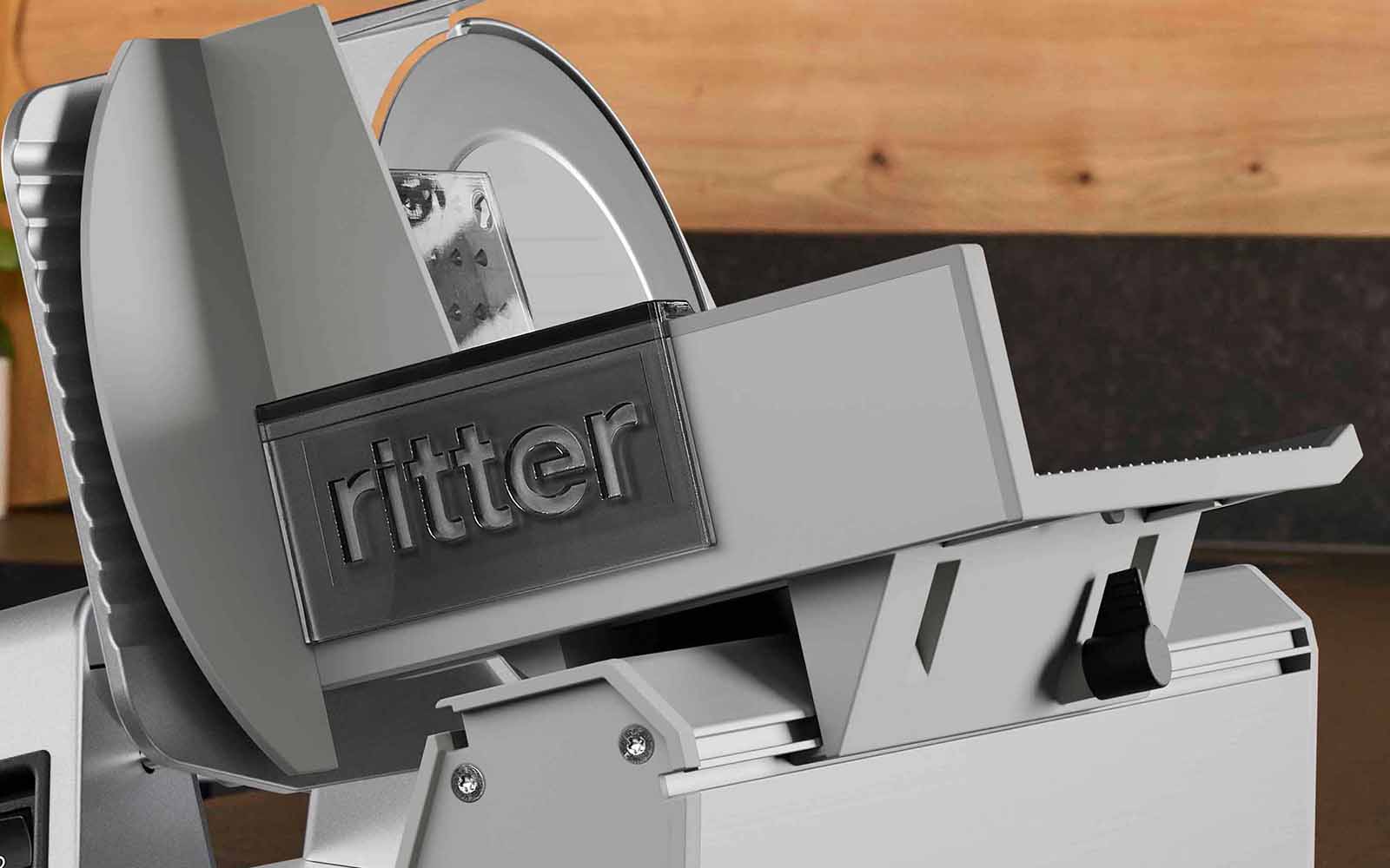 The carriage and the remnant holder of the deli slicer are attached to the machine.