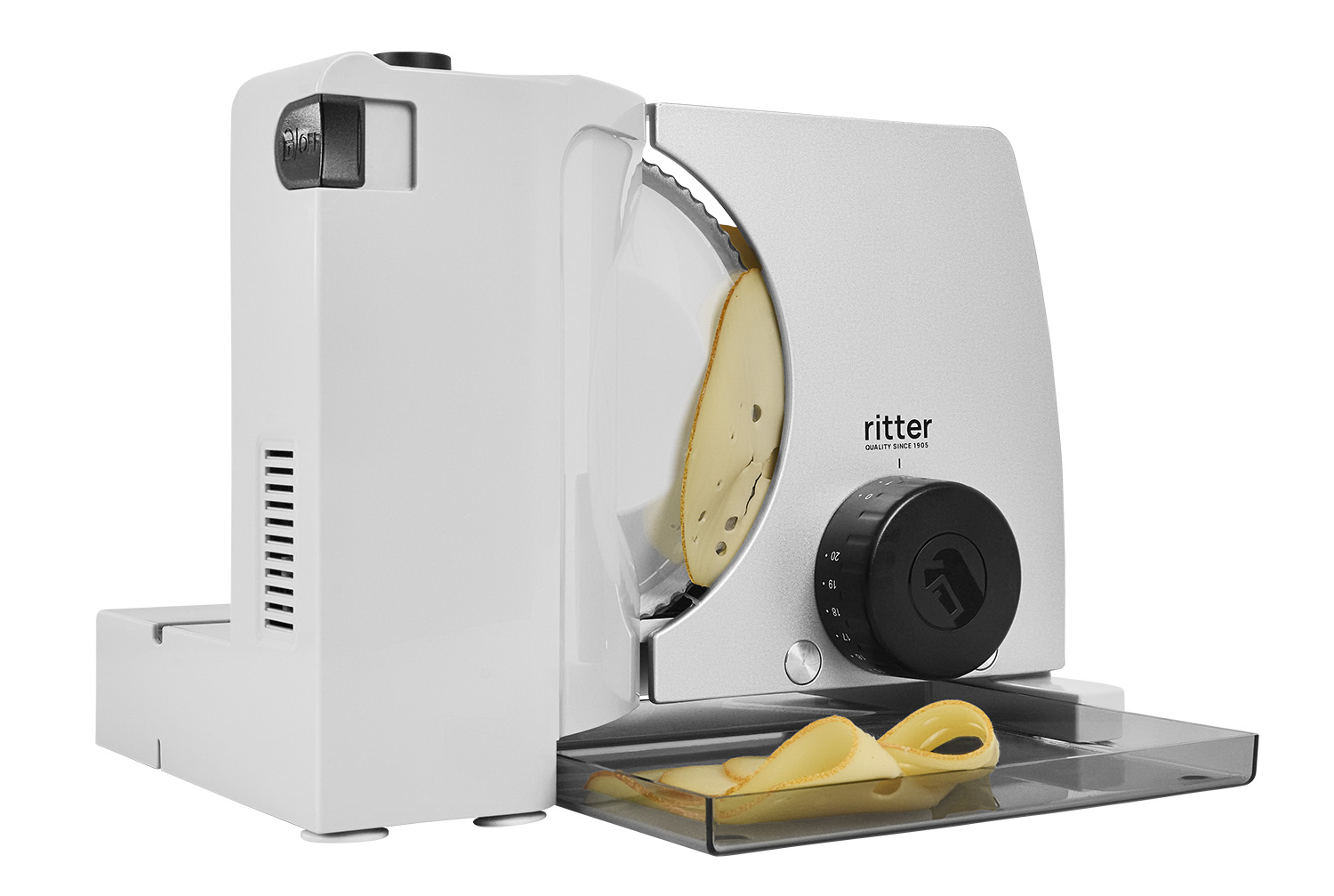 Electric food slicer in silver, angled view with sliced food