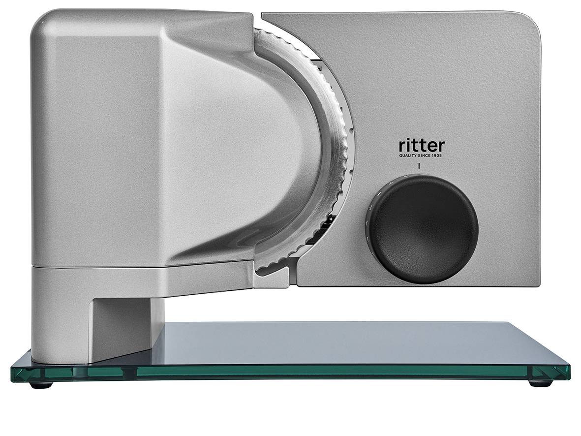 Electric food slicer in silver with black rotary knob and glass plate