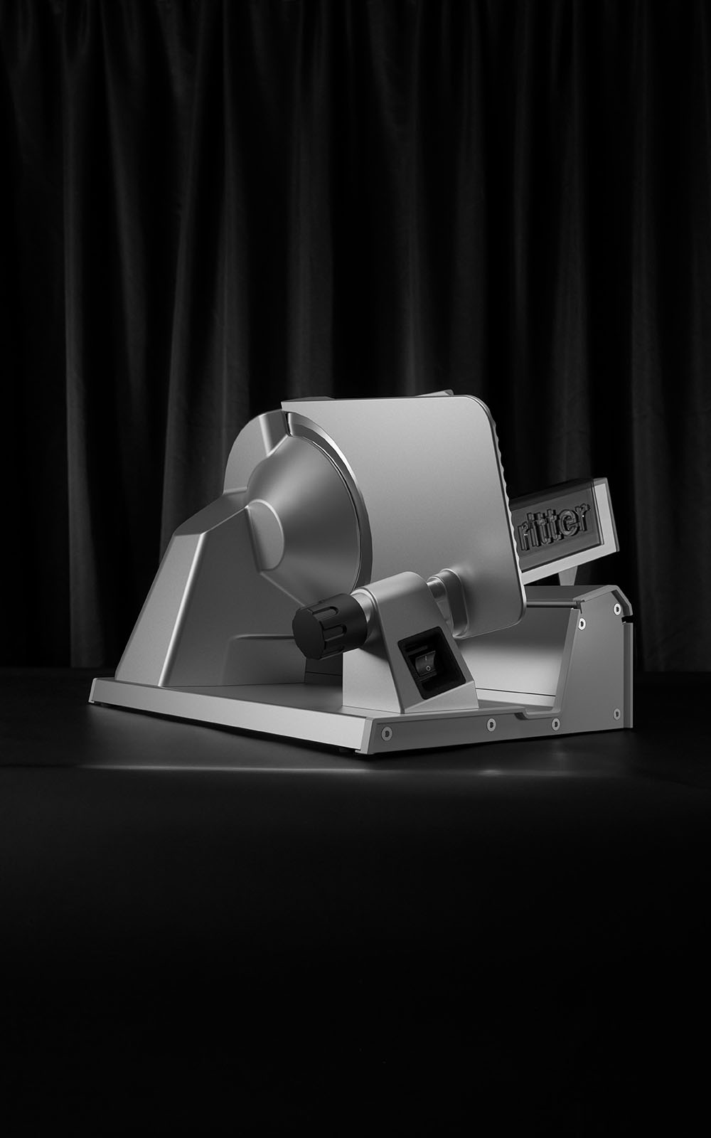 Deli slicer with black curtain in the background Deli slicer with black curtain in the background