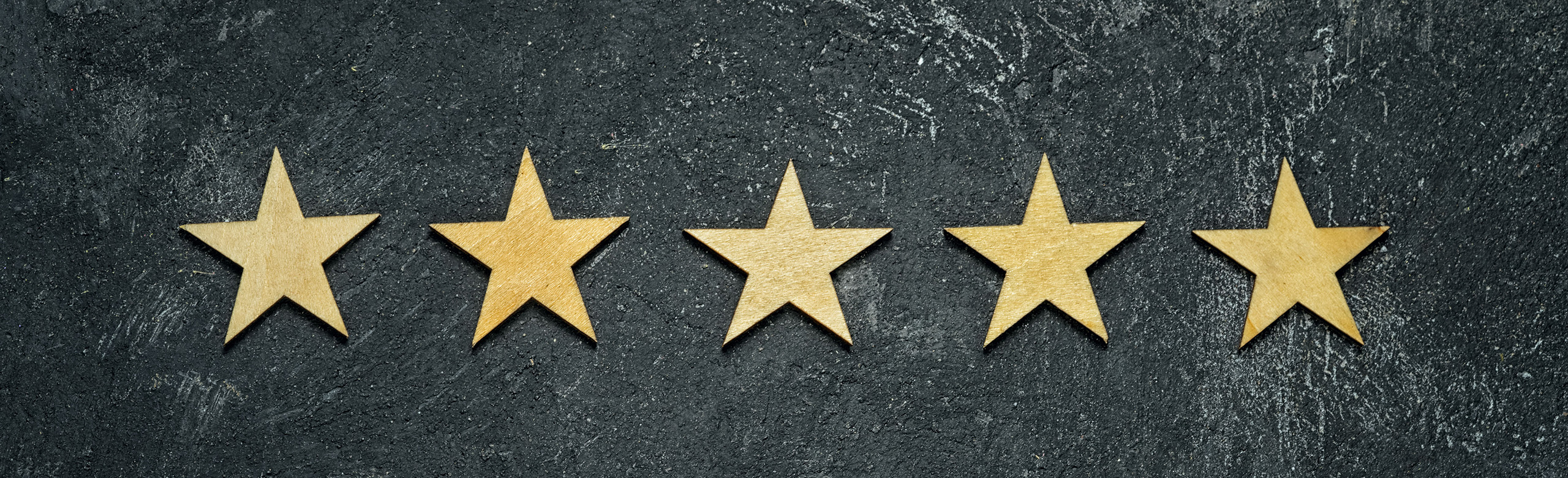 Kundenfavoriten 2025 5 goldene Sterne auf schwarzem Hintergrund