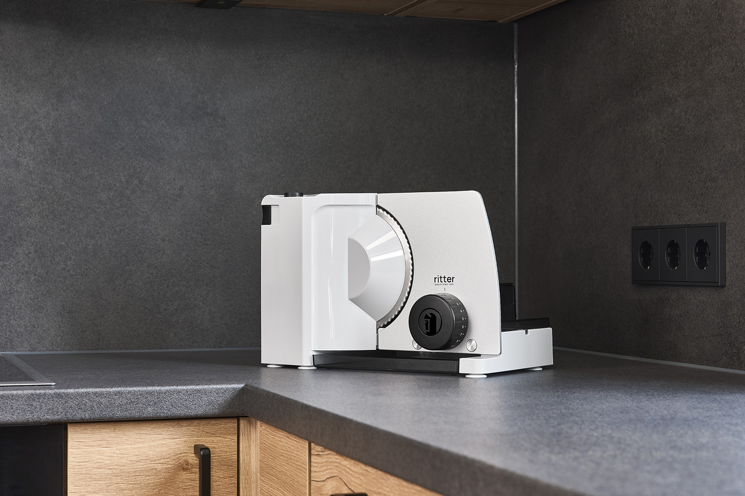 Electric food slicer with sliced cheese, in modern kitchen