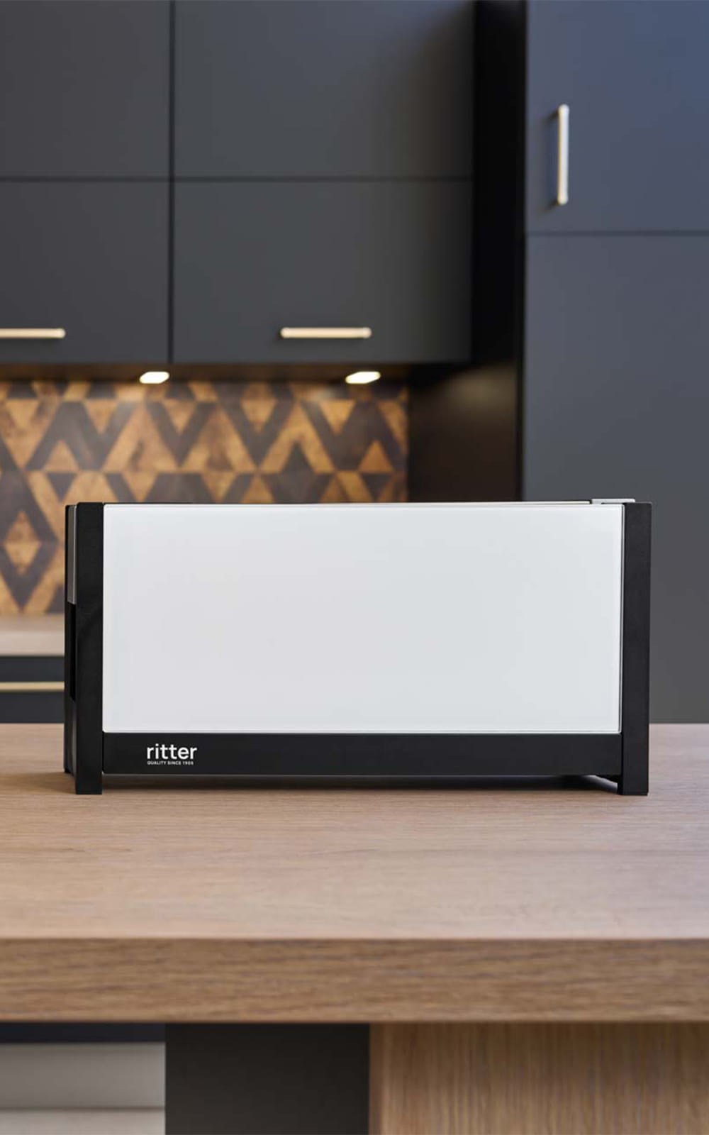 A picture of a white toaster standing on a kitchen platform. A picture of a white toaster standing on a kitchen platform.