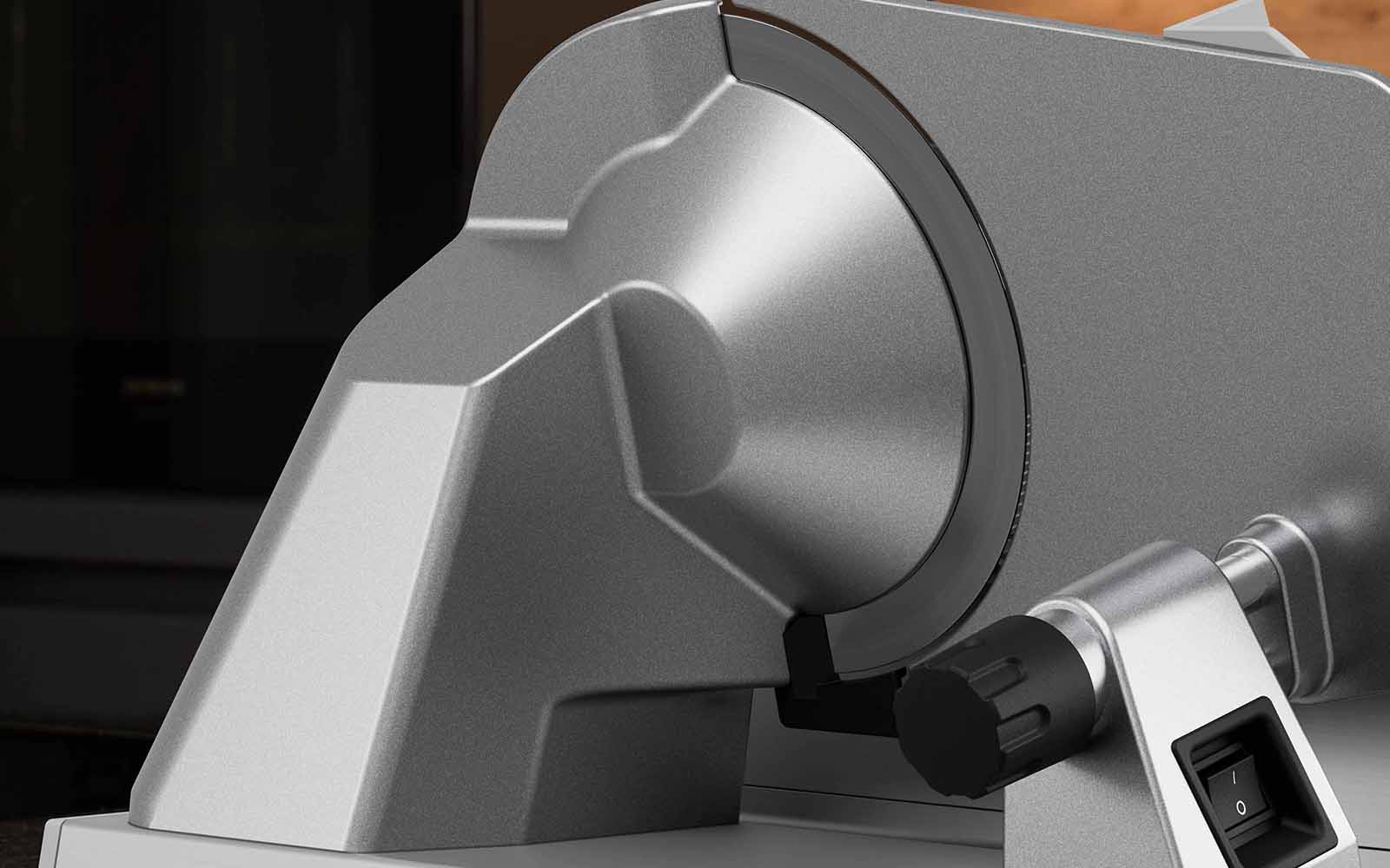 Silver motor head of the deli slicer with attached blade.