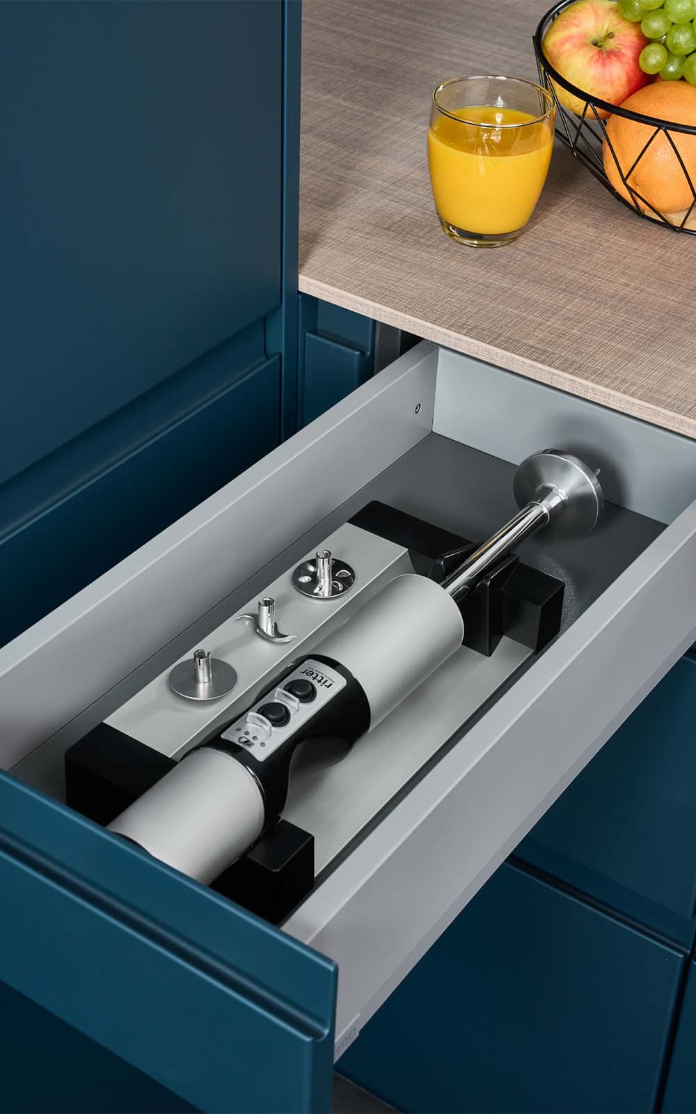 A picture of the built-in hand blender lying in a kitchen drawer. A picture of the built-in hand blender lying in a kitchen drawer.