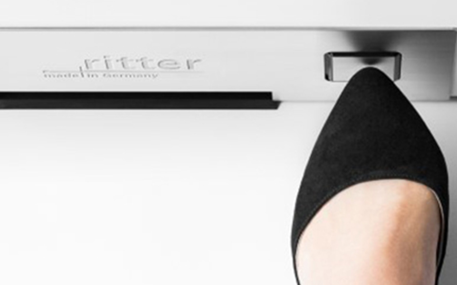 A foot that switches the built-in pedestal vacuum cleaner on.